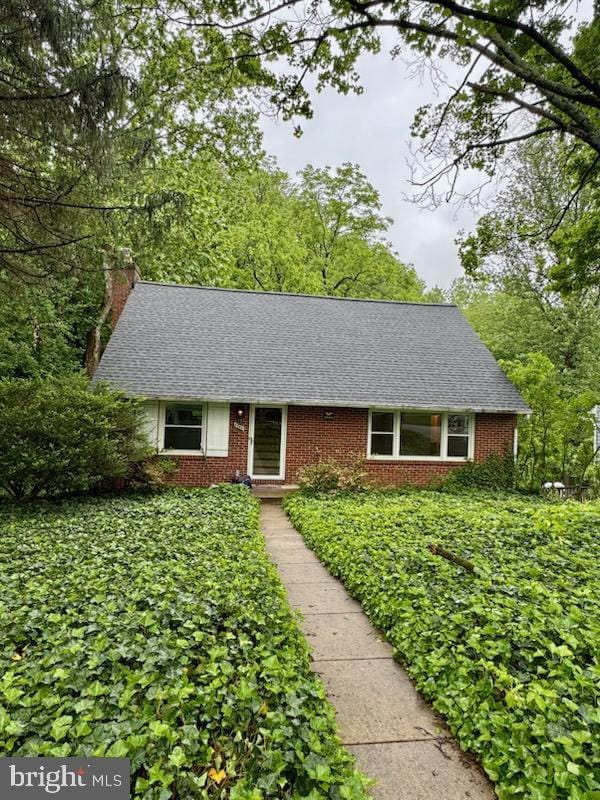 6748 Glenkirk Rd, Baltimore, MD 21239 - view of front of home featuring a chimney and brick siding