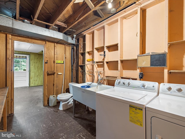 6748 Glenkirk Rd, Baltimore, MD 21239 - laundry room featuring dark floors, independent washer and dryer, and a sink