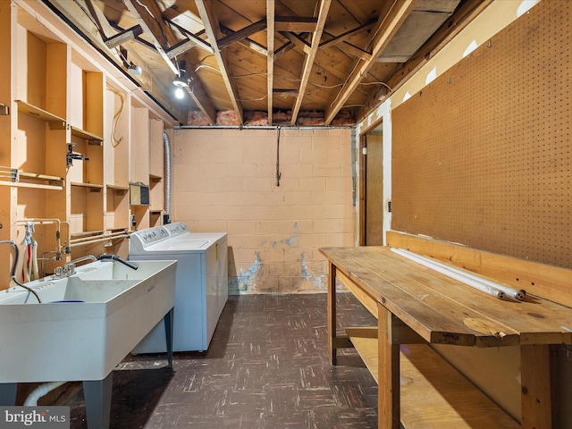 6748 Glenkirk Rd, Baltimore, MD 21239 - unfinished below grade area with dark floors, washer and clothes dryer, a sink, and concrete block wall