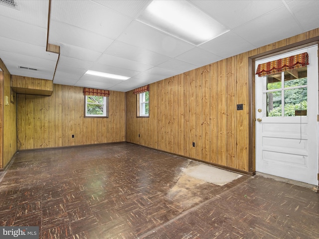 6748 Glenkirk Rd, Baltimore, MD 21239 - unfurnished room featuring wood walls and a paneled ceiling