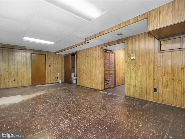 6748 Glenkirk Rd, Baltimore, MD 21239 - finished below grade area featuring wood walls, a drop ceiling, and baseboards