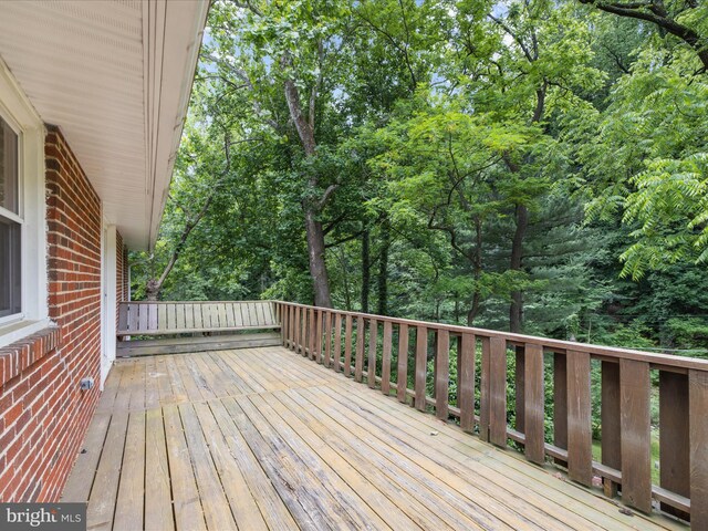 6748 Glenkirk Rd, Baltimore, MD 21239 - wooden deck featuring view of wooded area