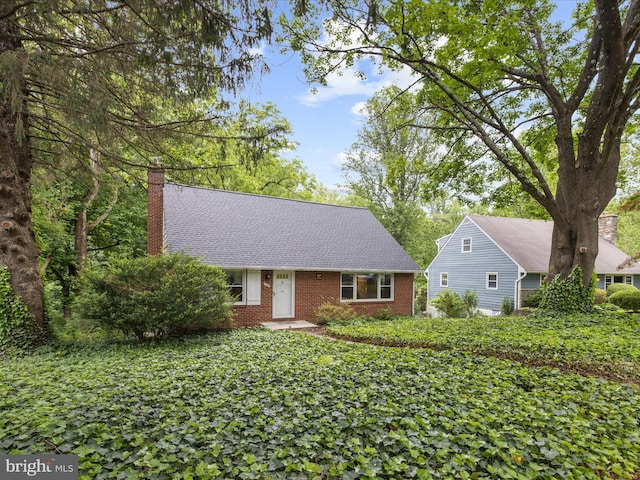 6748 Glenkirk Rd, Baltimore, MD 21239 - view of front of property featuring a chimney, brick siding, and a shingled roof