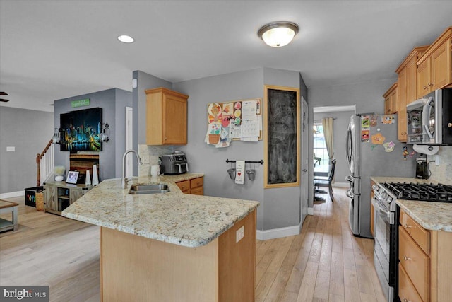 7 Kantner Ln N, Reading, PA 19607 - kitchen with gas range, stainless steel microwave, a sink, a peninsula, and baseboards