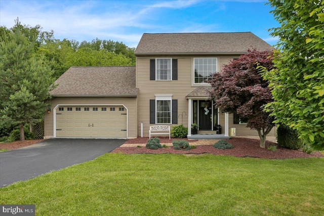 7 Kantner Ln N, Reading, PA 19607 - colonial house with driveway, a garage, a front yard, and a shingled roof