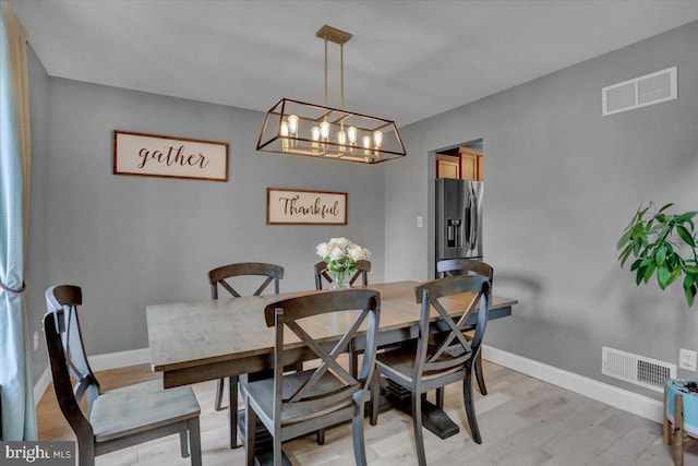 7 Kantner Ln N, Reading, PA 19607 - dining space featuring light wood finished floors, a chandelier, and baseboards