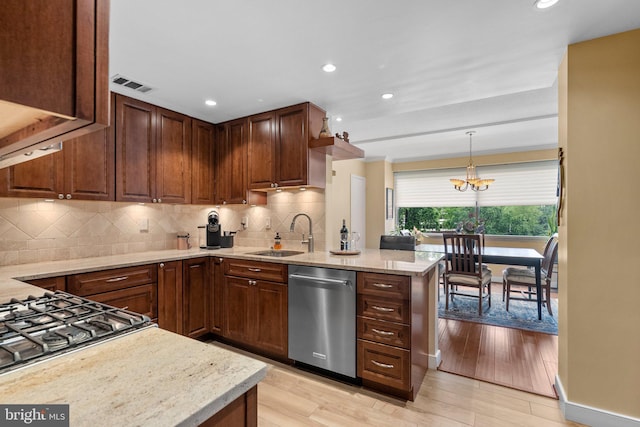 4515 Willard Ave Unit 610S, Chevy Chase, MD 20815 - kitchen with stainless steel dishwasher, a sink, decorative backsplash, a peninsula, and light wood-style flooring
