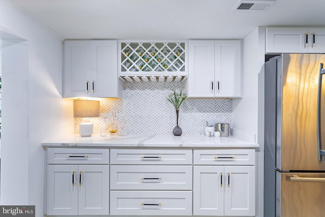 347 Clarks Tract Tract, Keswick, VA 22947 - kitchen featuring freestanding refrigerator, white cabinets, backsplash, and light stone countertops