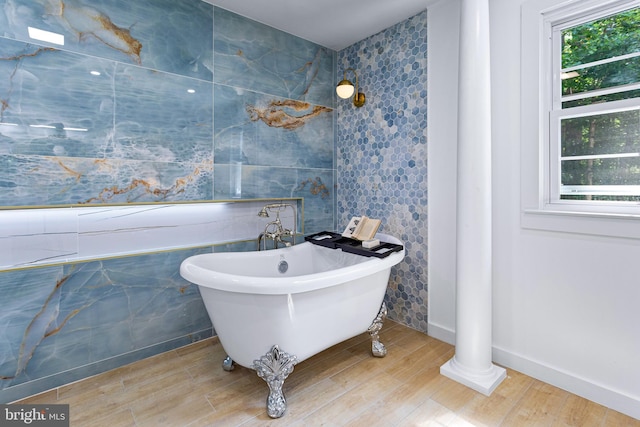 347 Clarks Tract Tract, Keswick, VA 22947 - bathroom featuring a freestanding bath, wood finished floors, and tile walls