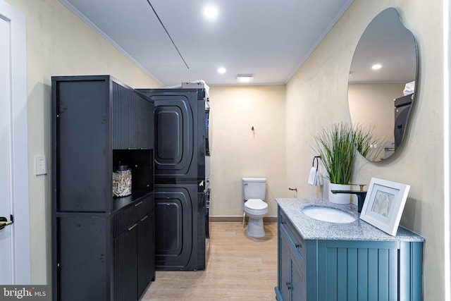 347 Clarks Tract Tract, Keswick, VA 22947 - bathroom with stacked washer / drying machine, wood finished floors, vanity, and crown molding