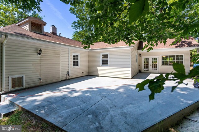 347 Clarks Tract Tract, Keswick, VA 22947 - back of property with french doors, a patio, a chimney, and roof with shingles