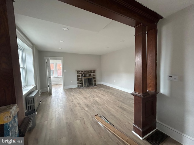 825 Jersey Ave, Gloucester City, NJ 08030 - unfurnished living room featuring radiator, wood finished floors, baseboards, a fireplace with flush hearth, and recessed lighting