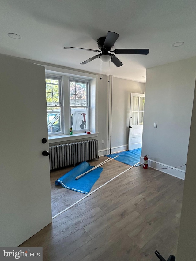 825 Jersey Ave, Gloucester City, NJ 08030 - exercise area with radiator heating unit, wood finished floors, baseboards, and a ceiling fan