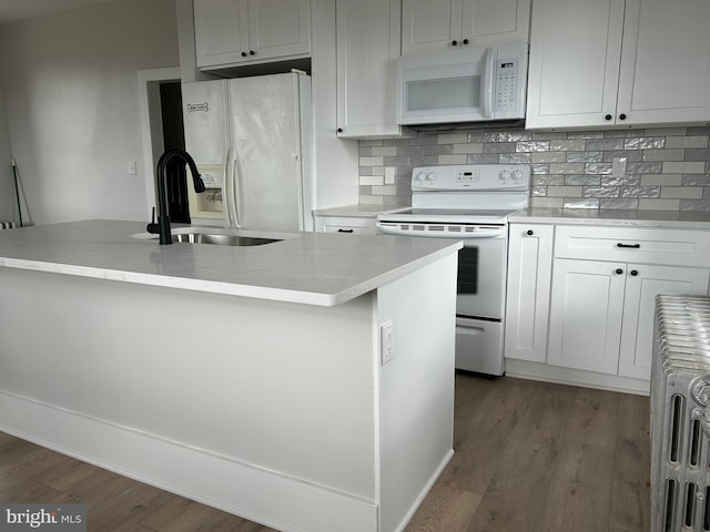 825 Jersey Ave, Gloucester City, NJ 08030 - kitchen featuring white appliances, a sink, wood finished floors, backsplash, and white cabinets