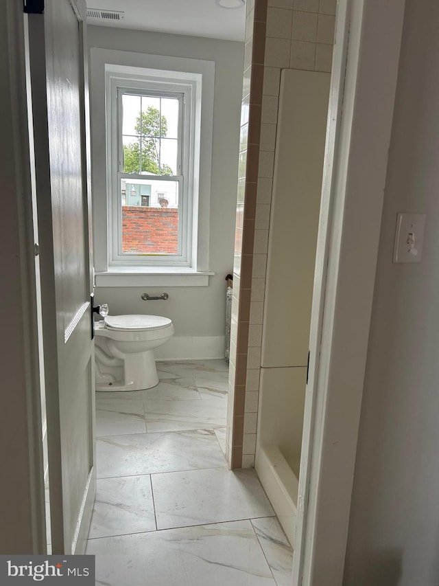 825 Jersey Ave, Gloucester City, NJ 08030 - bathroom featuring toilet, baseboards, marble finish flooring, and a shower