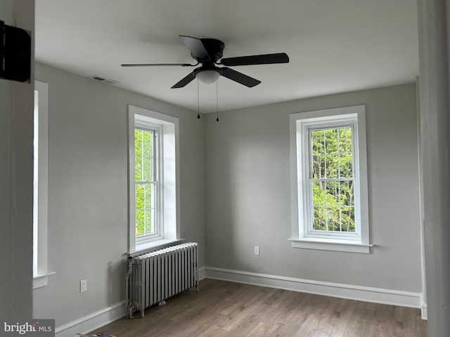 825 Jersey Ave, Gloucester City, NJ 08030 - empty room featuring radiator, baseboards, and wood finished floors