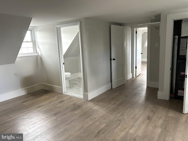 825 Jersey Ave, Gloucester City, NJ 08030 - unfurnished bedroom featuring light wood finished floors, baseboards, and ensuite bathroom