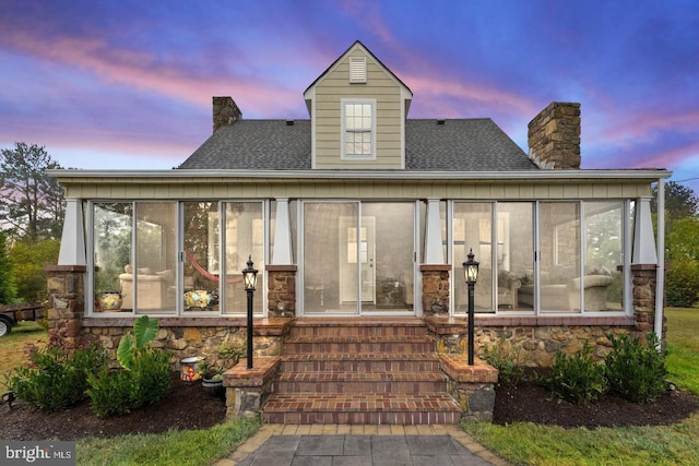 10488 Old Carolina Rd, Midland, VA 22728 - rear view of house featuring a sunroom, a chimney, stone siding, and a shingled roof