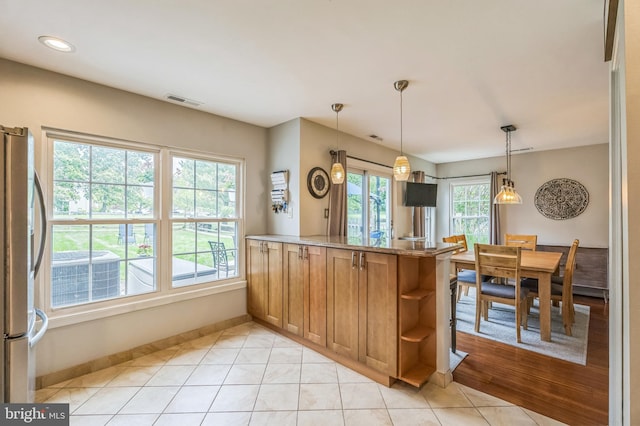 2 E Park Rd, Newtown, PA 18940 - kitchen featuring freestanding refrigerator, baseboards, brown cabinets, open shelves, and a peninsula