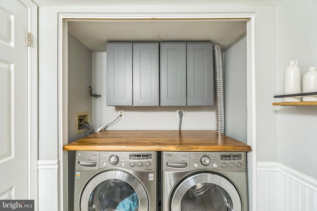 2 E Park Rd, Newtown, PA 18940 - laundry room featuring washing machine and dryer, cabinet space, wainscoting, and a decorative wall