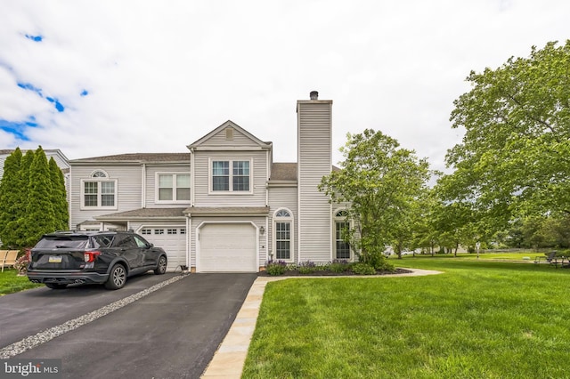 2 E Park Rd, Newtown, PA 18940 - view of property featuring driveway, a chimney, an attached garage, and a front yard