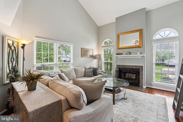 2 E Park Rd, Newtown, PA 18940 - living area with high vaulted ceiling, a fireplace, healthy amount of natural light, wood finished floors, and baseboards