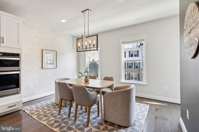 1909 Greenbriar Hall Rd, Dumfries, VA 22026 - dining room featuring wallpapered walls, baseboards, dark wood finished floors, and a chandelier