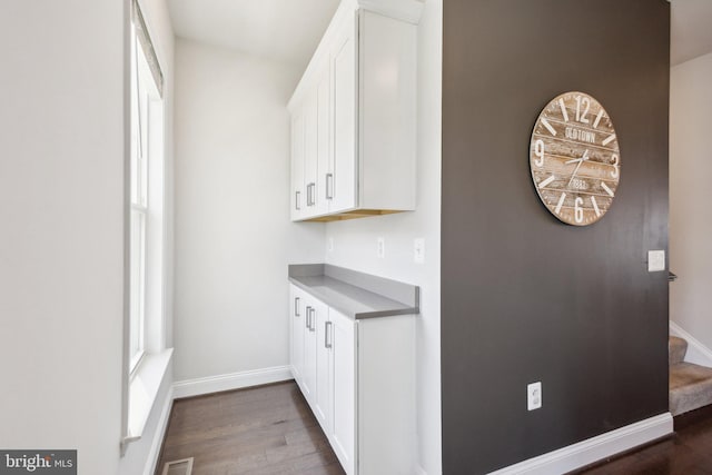 1909 Greenbriar Hall Rd, Dumfries, VA 22026 - bar with dark wood-style flooring, baseboards, and stairs