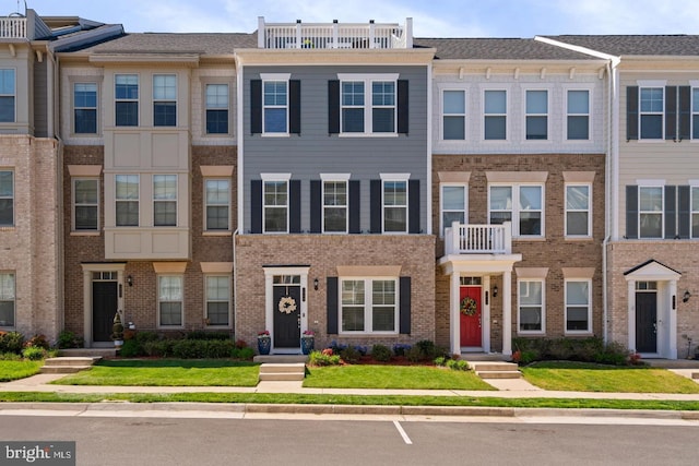 1909 Greenbriar Hall Rd, Dumfries, VA 22026 - townhome / multi-family property with brick siding and a front yard