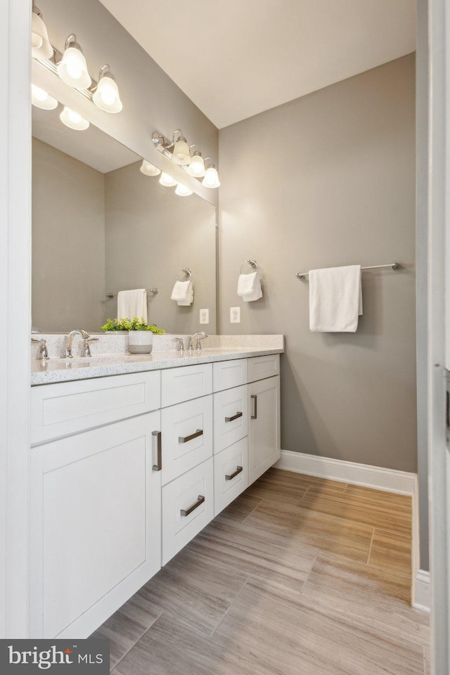 1909 Greenbriar Hall Rd, Dumfries, VA 22026 - full bathroom featuring double vanity and baseboards