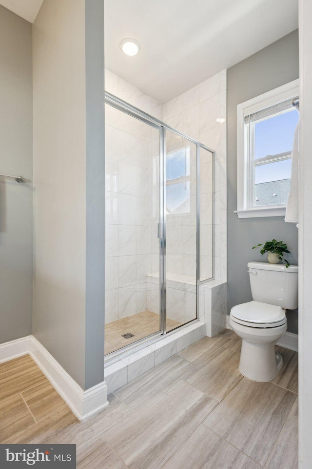 1909 Greenbriar Hall Rd, Dumfries, VA 22026 - bathroom with toilet, a stall shower, baseboards, and wood tiled floors