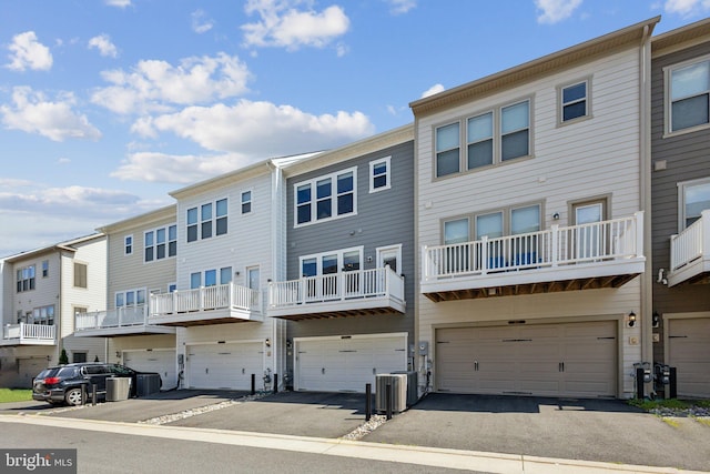 1909 Greenbriar Hall Rd, Dumfries, VA 22026 - back of property featuring an attached garage, driveway, and cooling unit