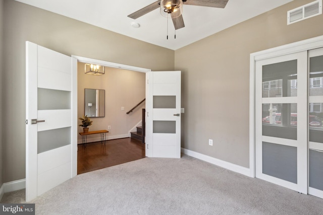 1909 Greenbriar Hall Rd, Dumfries, VA 22026 - carpeted empty room with a chandelier, stairway, ceiling fan, and baseboards
