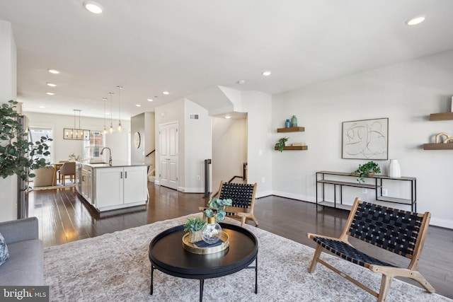 1909 Greenbriar Hall Rd, Dumfries, VA 22026 - living room featuring dark wood finished floors, recessed lighting, baseboards, and a chandelier