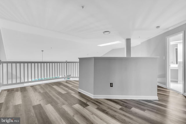 1334 Garden Wall Cir Unit 407, Reston, VA 20194 - empty room with wood finished floors, baseboards, crown molding, and fire sprinkler in ceiling