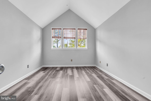 1334 Garden Wall Cir Unit 407, Reston, VA 20194 - unfurnished room with wood finished floors, lofted ceiling, and baseboards