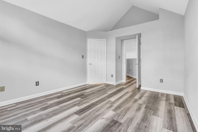 1334 Garden Wall Cir Unit 407, Reston, VA 20194 - unfurnished bedroom featuring wood finished floors, vaulted ceiling, and baseboards