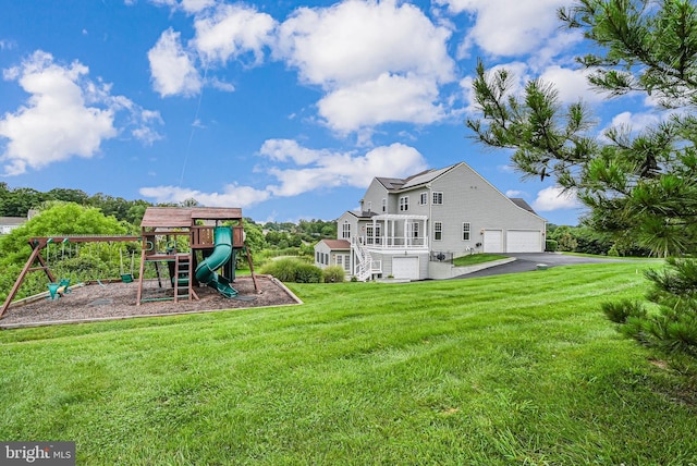 7425 Signal Hill Rd, Manassas, VA 20111 - view of grassy yard with a playground, stairs, asphalt driveway, and a garage