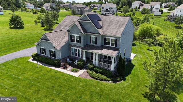7425 Signal Hill Rd, Manassas, VA 20111 - view of front of house featuring stone siding, a residential view, covered porch, a front yard, and roof with shingles