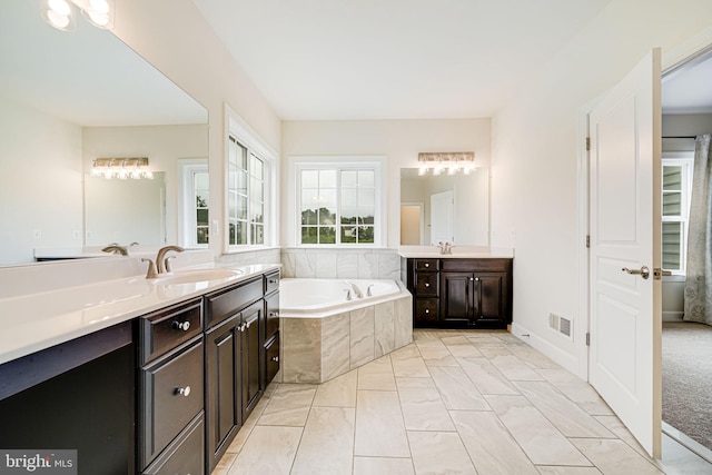 7425 Signal Hill Rd, Manassas, VA 20111 - bathroom featuring two vanities, a bath, and marble finish flooring
