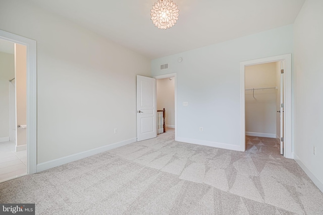7425 Signal Hill Rd, Manassas, VA 20111 - unfurnished bedroom featuring a spacious closet, carpet floors, ensuite bath, and a closet