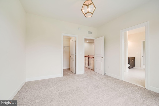 7425 Signal Hill Rd, Manassas, VA 20111 - unfurnished bedroom with light carpet and a walk in closet