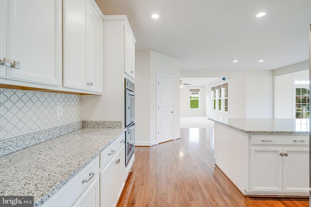 7425 Signal Hill Rd, Manassas, VA 20111 - kitchen featuring healthy amount of natural light, tasteful backsplash, white cabinetry, light wood finished floors, and recessed lighting