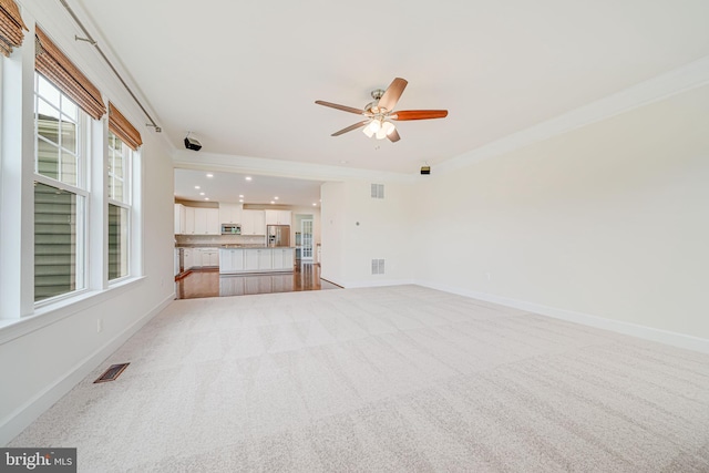 7425 Signal Hill Rd, Manassas, VA 20111 - unfurnished living room featuring ceiling fan, ornamental molding, light colored carpet, and recessed lighting