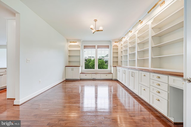 7425 Signal Hill Rd, Manassas, VA 20111 - unfurnished dining area featuring hardwood / wood-style flooring, a chandelier, and built in shelves