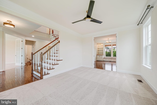 7425 Signal Hill Rd, Manassas, VA 20111 - unfurnished living room with ceiling fan, stairs, ornamental molding, french doors, and wood finished floors