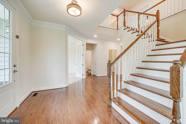 7425 Signal Hill Rd, Manassas, VA 20111 - foyer with wood finished floors, stairs, crown molding, french doors, and recessed lighting