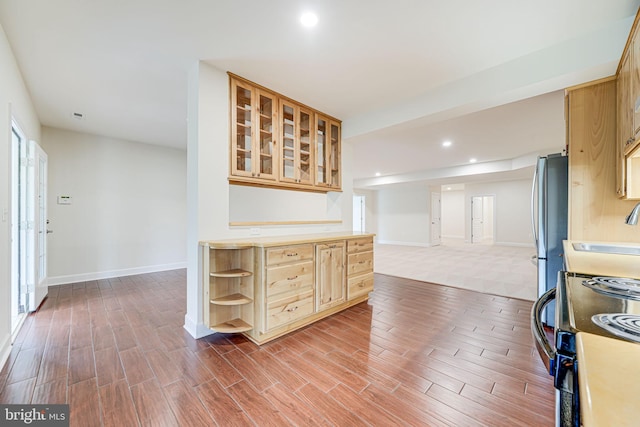 7425 Signal Hill Rd, Manassas, VA 20111 - kitchen featuring range with electric cooktop, light wood finished floors, freestanding refrigerator, recessed lighting, and glass insert cabinets