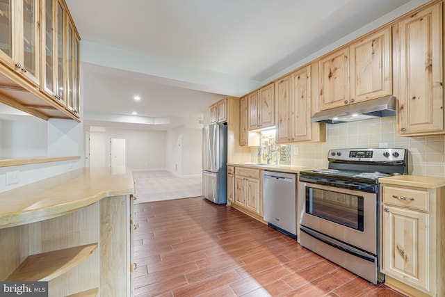 7425 Signal Hill Rd, Manassas, VA 20111 - kitchen featuring appliances with stainless steel finishes, under cabinet range hood, light brown cabinetry, light countertops, and recessed lighting