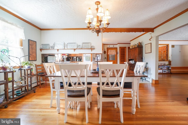 5509 Waterview Dr, Cambridge, MD 21613 - dining area with ornamental molding, a chandelier, a textured ceiling, wood finished floors, and baseboards